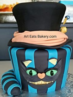 a blue and black cake with a top hat on it