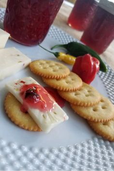 some crackers and cheese are on a white plate