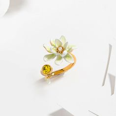 Gardenia Ring is a flower ring from Selenichast jewelry store. This is from nature jewelry and according its material, it??s also enamel jewelry which can be adjusted. Dress up your hand with this delicate ring. This adjustable flower ring features a white gardenia facing a yellow faceted glass stone. Simple yet delicate. This stylish designer jewel is almost perfect for all occasions and help add a touch of femininity and brightness to your outfits. Yellow Gold Enamel Flower Jewelry, Gold Flower-shaped Enamel Ring, Gold Enamel Flower Ring, Gold Enamel Flower Ring For Anniversary, Floral Enamel Wedding Jewelry, Anniversary Enamel Flower Ring, Anniversary Flower Ring In Enamel, Anniversary Round Flower Enamel Ring, Enamel Flower-shaped Jewelry For Wedding