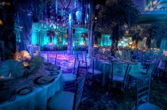 an elaborately decorated banquet hall with blue lighting