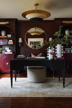 a living room filled with furniture and a large mirror on the wall over a table