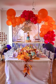 the table is set up with many balloons