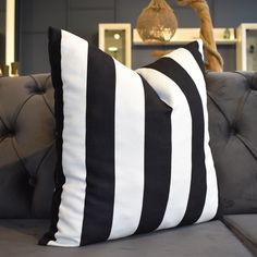 two black and white striped pillows on a couch