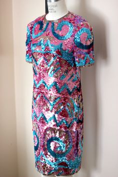 "So fun and so funky!! Vintage 80 sequin/bead hot pink, blue, silver dress! Sooo shiny and sparkly. You will definitely be the center of attention in this unique piece! 100% silk Zips in the back and is in Very good condition! I do not see any sequin loss. Hot pink silk lining Stunning geometric design with beautiful details Measuring: 38\" long Bust: 34\" Waist: 30\" Hip 36\" Pet free/ smoke free Enjoy!" Pink Sequin Dress For Festive Occasions, Festive Pink Contrast Sequin Dress, Pink Sequined Disco Dress, Pink Disco Sequin Dress, Pink Sequin Dress With Glitter For Holidays, Holiday Pink Sequin Dress With Glitter, Pink Sequin Glitter Dress For Holiday, Festive Pink Dress With Contrast Sequin, Pink Sequin Spring Dress For Festive Occasions