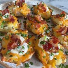 a plate topped with potatoes covered in bacon and cheese