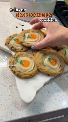 someone is decorating some cookies with an egg in the middle and another cookie on top