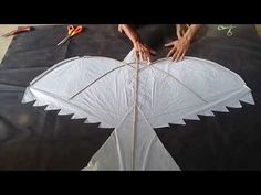 someone is working on a kite that looks like an eagle or bird's wing