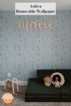 a child's room with a green couch and wallpaper