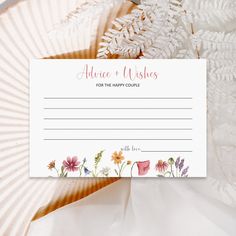 a card that has flowers on it and the words advice to wishes for the happy couple