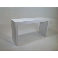 a white table sitting on top of a white floor