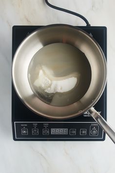 a frying pan with some food in it on top of a stove burner