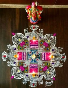 an intricately designed gandapa hanging on the wall