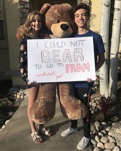 a man and woman standing next to a teddy bear holding a sign that says i could not bear to go to prom