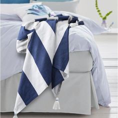 a blue and white blanket on top of a bed