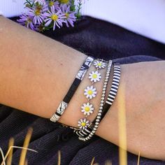 This dainty little daisy bracelet will never tarnish! It's made of stainless steel and enamel, so you can wear it with confidence. You can choose between gold or silver for the base metal color, and there are multiple color options for the flowers. Plus, this bracelet is adjustable, so it should fit almost anyone! Live in it, love it, and wear it proudly knowing it is made with high-quality materials. Spring Friendship Bracelets For Everyday Wear, Spring Everyday Friendship Bracelets, Trendy Silver Hypoallergenic Friendship Bracelets, Trendy Hypoallergenic Silver Friendship Bracelets, Adjustable Silver Daisy Jewelry, Adjustable Silver Daisy-shaped Jewelry, Trendy Silver Flower Bracelets, Adjustable Stainless Steel Beaded Bracelets, Adjustable Daisy Everyday Jewelry