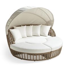 an outdoor daybed with white cushions and pillows