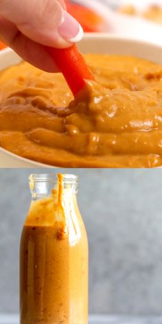 a person dipping some kind of sauce in a bowl with a spoon and another hand holding a small jar