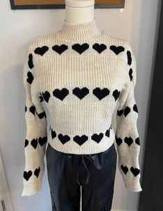 Cozy up in our Sandra Heart Print Mock Neck Sweater! 💖 Embrace the perfect blend of softness and comfort. Whether it's a Valentine's date, a casual day out, daily wear, outdoor adventures, a vacation getaway, or a stylish school look - this sweater has you covered. Stay warm, stylish, and comfortably chic! Wear it tucked in for a polished vibe or keep it long for a laid-back feel. 💕    From Paris - Estee Brown Paris 100% Acrylic  One Size Trendy Heart Print Tops For Winter, Casual Heart Print Sweater For Winter, Casual Winter Sweater With Heart Print, Fitted Winter Top With Heart Print, Fitted Heart Print Sweater For Fall, Snug Knit Casual Outerwear, Trendy Heart Print Tops For Fall, Trendy Heart Print Sweater For Winter, Trendy Fall Sweater With Heart Print