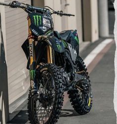 a dirt bike parked next to a building