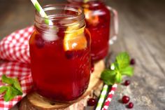 two mason jars filled with cranberry lemonade