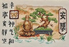 a cross stitch picture with chinese writing and an image of a cat sitting in front of a bonsai tree