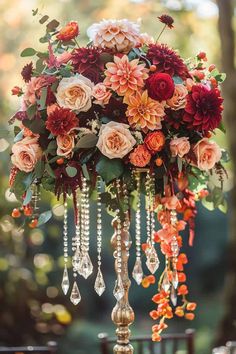 a tall vase filled with flowers on top of a table