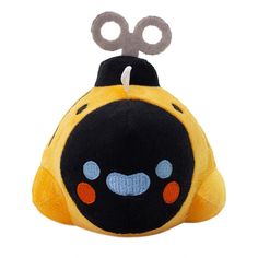 a yellow and black stuffed animal with scissors on it's head