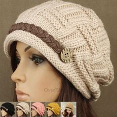 a mannequin head wearing a knitted hat with braids and buttons on it