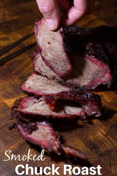 someone is slicing up some meat on a cutting board with the words smoked chuck roast