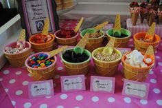 ice cream cones with candy in them on a table