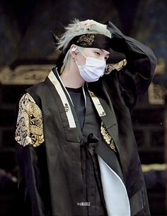 a person wearing a mask and black clothing