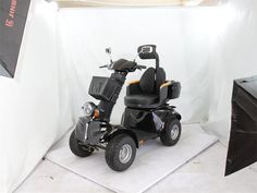 an electric scooter parked in front of a white backdrop