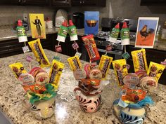 candy bars and candies are sitting on the kitchen counter