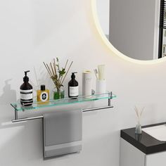 a bathroom with a sink, mirror and soap dispensers on the counter