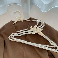 three strands of pearls with bows on them