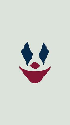 the face of a clown with two blue eyes and one red nose on a gray background