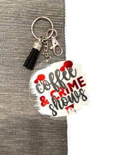 there is a keychain with the words coffee and game show on it's side