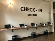 the check - in stations are lined up against the wall