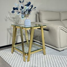 a living room with a couch, table and vase on the floor in front of it