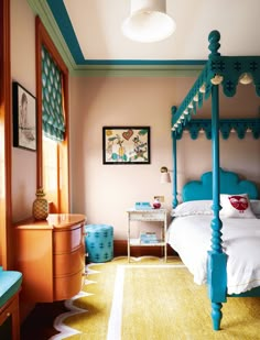 a bed room with a neatly made bed next to a dresser and chair in it