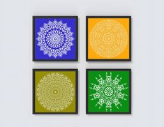 four framed artwork pieces with different colors and designs on the same wall, each depicting an intricate design