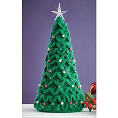 a green christmas tree sitting on top of a table