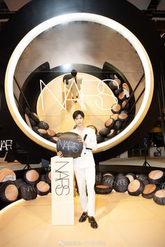 a man standing in front of a display with makeup products on it's sides