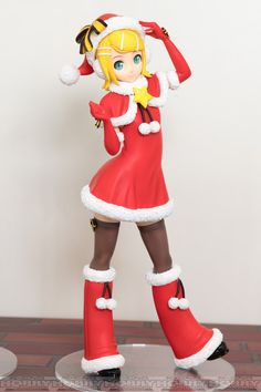 a figurine is dressed in red and white with her arms behind her head