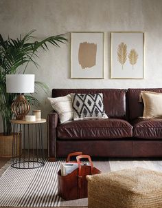 a living room filled with furniture and paintings on the wall next to a rug covered floor