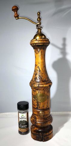 an old fashioned oil lamp next to a jar of mustard