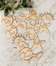 wooden cutouts with names on them sitting on a marble surface