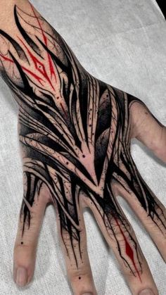 a person's hand with black and red ink on it