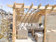 an outdoor seating area with wooden slatted walls