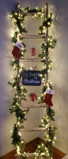 a ladder decorated with christmas lights and stockings